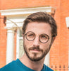 Ryan wears Poppy round frames in black from the William Morris Gallery Collection